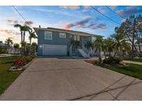 Two-story home with a spacious driveway, two car garage, and beautiful landscaping at 8408 Damen Ln, Port Richey, FL 34668