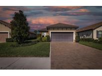 Charming one-story home with a two-car garage, paver driveway and manicured landscaping at 11383 Callisia Dr, Odessa, FL 33556