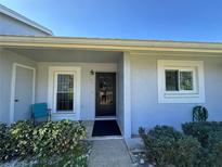 Inviting front entrance with meticulously maintained landscaping and a calming blue exterior at 12205 Darwood Dr # 12205, Hudson, FL 34667