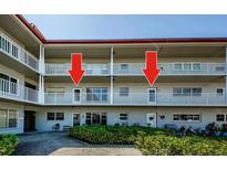 This condo has a lovely exterior with balconies, a manicured lawn, and well-maintained landscaping at 2261 Swedish Dr # 33&35, Clearwater, FL 33763