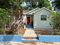 Charming single-story home with a vibrant red front door and a well-maintained walkway at 4009 N Seminole Ave, Tampa, FL 33603
