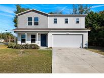 Charming two-story home with a two car garage and lovely landscaping at 6209 Radford St, Spring Hill, FL 34606