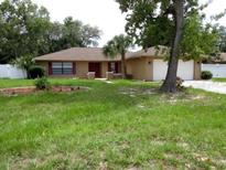 Charming single-story home featuring a well-maintained lawn and mature trees at 10020 Vancouver Rd, Spring Hill, FL 34608