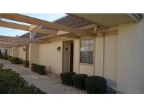 Charming condo features a covered entryway, well-maintained landscaping, and a welcoming front door at 11140 Carriage Hill Dr # 3, Port Richey, FL 34668