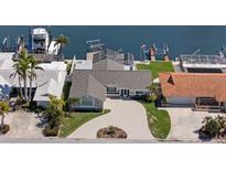 Well maintained waterfront home featuring lush landscaping, a circular driveway, and a private boat dock with lift at 5000 Galleon Ct, New Port Richey, FL 34652