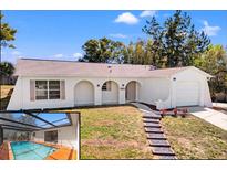 Charming single-story home featuring stucco siding, a front porch, and a well-manicured lawn at 7048 Oberon Ave, Spring Hill, FL 34608