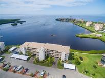 Stunning aerial view of waterfront condominium complex with beautiful landscaping and covered parking at 8211 Brent St # 816, Port Richey, FL 34668
