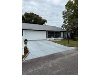 Charming single-story home features a two-car garage and screened in porch at 11121 Linkside Dr # 11121, Port Richey, FL 34668