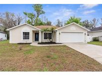 Charming single-story home with a well-maintained lawn and attached two car garage at 12112 Shearwater Dr, New Port Richey, FL 34654