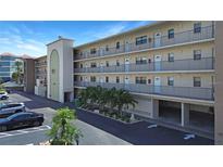 Three-story condo building featuring multiple units with balconies and well-maintained landscaping at 14001 Gulf Blvd # 310, Madeira Beach, FL 33708