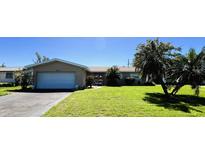 Charming single-story home with a lush green lawn and mature trees offering shade at 2630 63Rd S Ave, St Petersburg, FL 33712