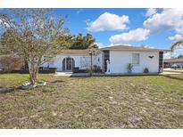 Charming single-story home featuring a well-kept lawn and a decorative front entrance at 4560 Lamson Ave, Spring Hill, FL 34608