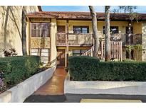 Charming condo featuring stone accents and a tiled roof, complemented by lush landscaping and a private entrance at 7650 Forest Trl # 7, Port Richey, FL 34668