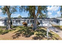 Charming single-story home with well-maintained lawn and mature trees providing ample shade at 10841 Scenic Dr, Port Richey, FL 34668