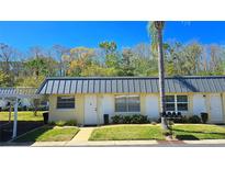 Charming townhouse with a covered parking spot and a well-maintained lawn at 11817 Bayonet Ln, New Port Richey, FL 34654