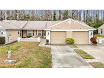 Inviting single story home with two car garage, neutral paint, and well-manicured lawn in a desirable community at 13227 Molitor Ct, Hudson, FL 34669