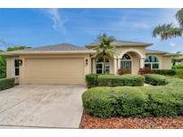 Inviting home with manicured landscaping, attached garage, and a blue sky overhead at 2336 Edelweiss Loop, Trinity, FL 34655