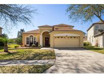 Charming two-story home with a well-manicured lawn and an attached two-car garage at 3042 Gianna Way, Land O Lakes, FL 34638
