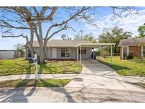 Charming single-story home with a carport and a well-maintained front yard at 3209 Kismet Ct, New Port Richey, FL 34655
