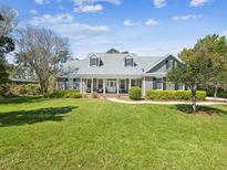 Charming single-Gathering home with a well-manicured lawn, a welcoming front porch, and attractive landscaping at 3733 Wiregrass Rd, New Port Richey, FL 34655