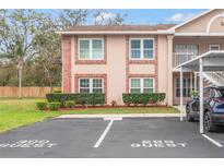Charming two-story condo with brick accents, manicured landscaping, and convenient guest parking spaces at 6440 Spring Flower Dr # 11, New Port Richey, FL 34653