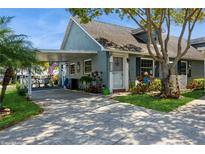 Charming home features a covered carport, mature trees, and beautifully landscaped front yard at 6710 Devonshire Ln # 10A, New Port Richey, FL 34653