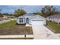 Charming single-story home features a two-car garage and landscaped front yard at 10114 Briar Cir, Hudson, FL 34667