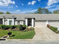 Charming single-story home with well-manicured lawn and attached two-car garage at 18045 Tarrington Pl, Hudson, FL 34667