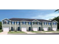 Charming new townhomes offer a blend of modern design and comfortable living, featuring individual garages and appealing facades at 20338 Lou Angela Ln, Lutz, FL 33558