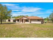 Charming single-story home with a well-maintained yard and barn, offering a peaceful countryside setting at 28089 Old Trilby Rd, Brooksville, FL 34602