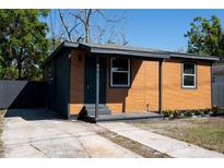 A charming single-story home with a two-tone exterior and a well-maintained front yard at 4601 N 37Th St, Tampa, FL 33610