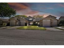 Dusk view showcasing well-maintained two-story homes with garages, illuminated by soft lighting at 6518 Remus Dr, New Port Richey, FL 34653