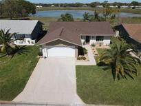 Charming single-story home boasts well-manicured landscaping and a spacious driveway, close to lake at 8231 Palencia Dr, Port Richey, FL 34668