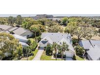 Inviting home featuring well-maintained landscaping, dual garages and a charming architectural design at 9144 Bassett Ln, New Port Richey, FL 34655