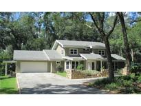 Charming two-story home with a well-manicured lawn and an attached two car garage at 39127 Pretty Pond Rd, Zephyrhills, FL 33540