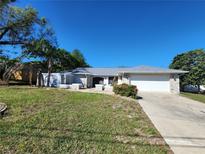 Charming single-story home with well-maintained lawn, stone accents and a two car garage at 5227 Kirkwood Ave, Spring Hill, FL 34608