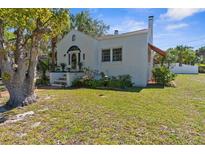 Charming home featuring a unique tiled staircase, arched entryway, and well-maintained landscaping at 6244 Warren Ave, New Port Richey, FL 34653
