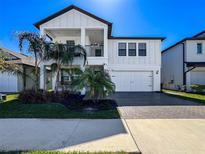 Charming two-story home with a white exterior, balcony, and neatly landscaped front yard at 8132 Capstone Ranch Dr, New Port Richey, FL 34655