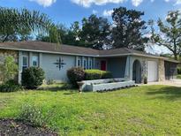 Charming single-story home with well-manicured lawn and beautiful landscaping, offering great curb appeal at 12330 Comstock St, Spring Hill, FL 34609