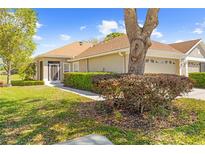 Charming single-story home featuring a well-maintained lawn and mature landscaping, creating inviting curb appeal at 14471 Sterling Run, Spring Hill, FL 34609