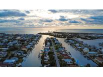 Beautiful aerial view of waterfront homes along a canal, leading out to the open water at 4964 Cedarbrook Ln, Hernando Beach, FL 34607