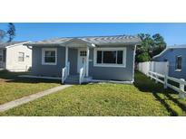 Charming single-story home featuring a well-maintained lawn and inviting entryway at 858 51St N Ave, St Petersburg, FL 33703