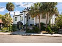 A distinctive house featuring classic architecture, with palm trees accentuating its unique design and appeal at 200 Grand Blvd, Tarpon Springs, FL 34689