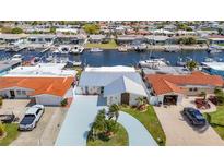 Waterfront home with a metal roof, nicely manicured landscaping, and canal access for boating and other water activities at 4936 Dory Dr, New Port Richey, FL 34652