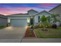 Charming single-Gathering home featuring a two-car garage and well-manicured landscaping at 582 8Th Nw St, Ruskin, FL 33570