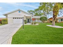 Charming single-story home with well-manicured lawn and inviting curb appeal at 7107 Pond View Ct, Spring Hill, FL 34606