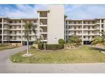 Well-maintained condominium building with multiple balconies, manicured landscaping, and ample parking at 8251 Brent St # 918, Port Richey, FL 34668