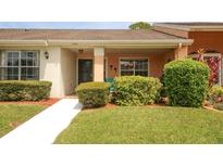 Charming home featuring a well-manicured lawn, a front door, and a bright, inviting entryway at 9321 Whitstone Ct, New Port Richey, FL 34655
