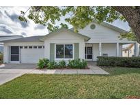 Charming single-story home featuring a well-maintained lawn, white brick, and a cozy front porch at 9336 Cape Charles Ave, New Port Richey, FL 34655