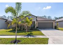 Charming single Gathering home featuring a well-manicured lawn and two car garage at 1957 Fan Aloe Way, Ruskin, FL 33570